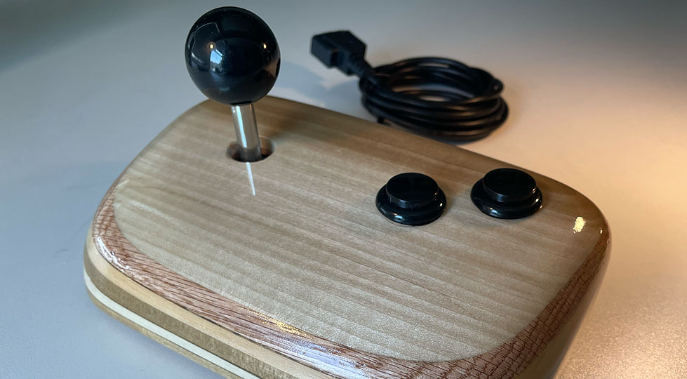 photograph of a wooden video game joystick